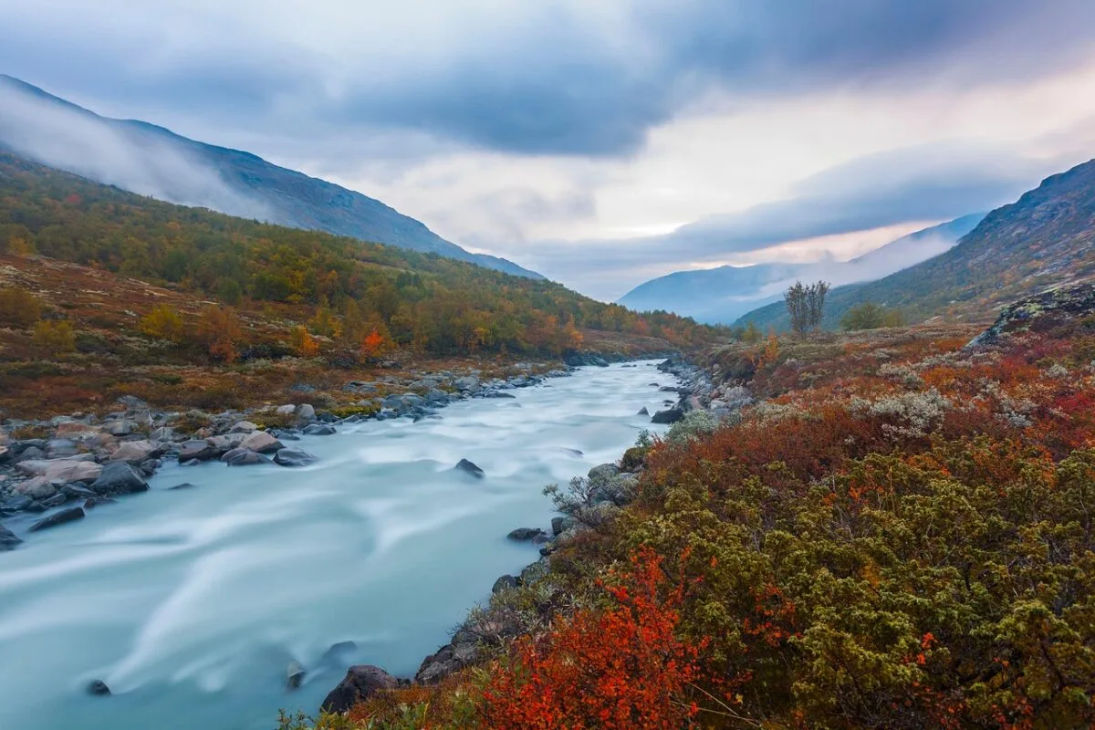 large river with fall colors in the mountains