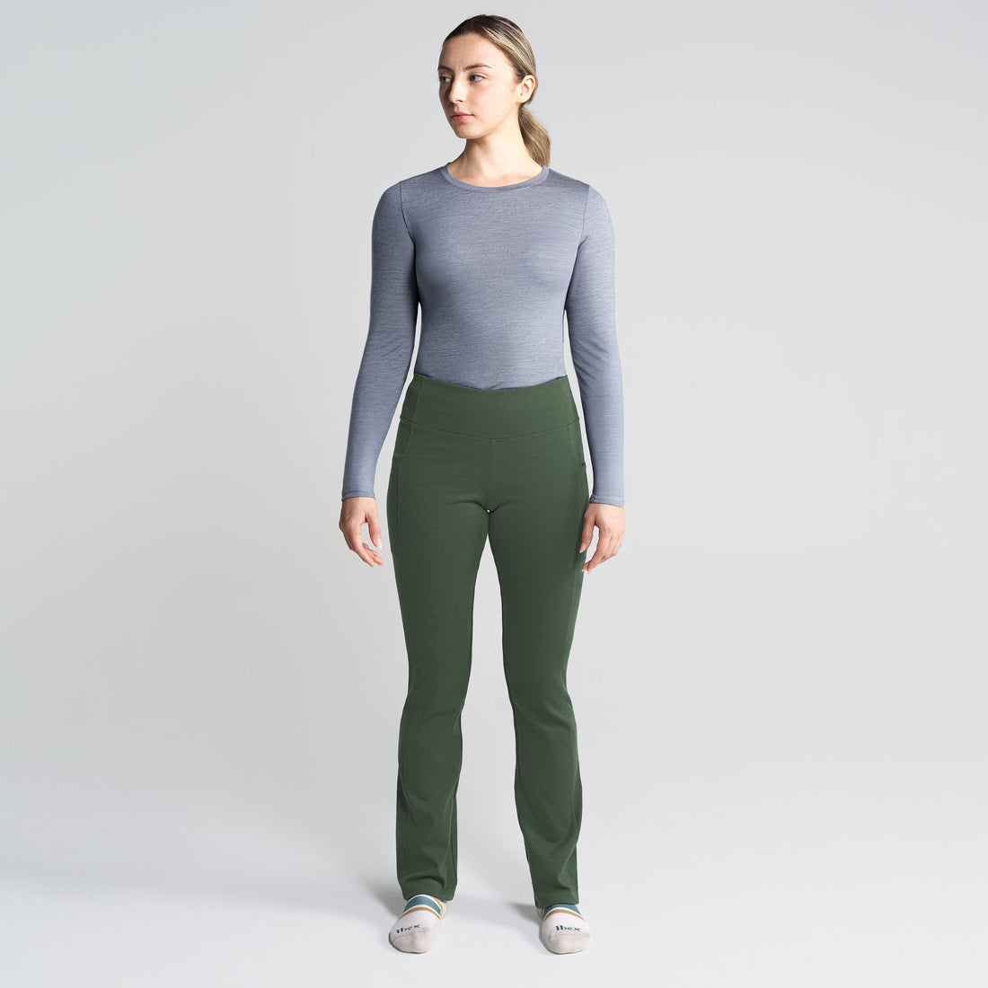 Woman wearing the Ibex Lizzi Tavern merino travel pant, a tapered-leg travel trouser with hidden zip pockets.