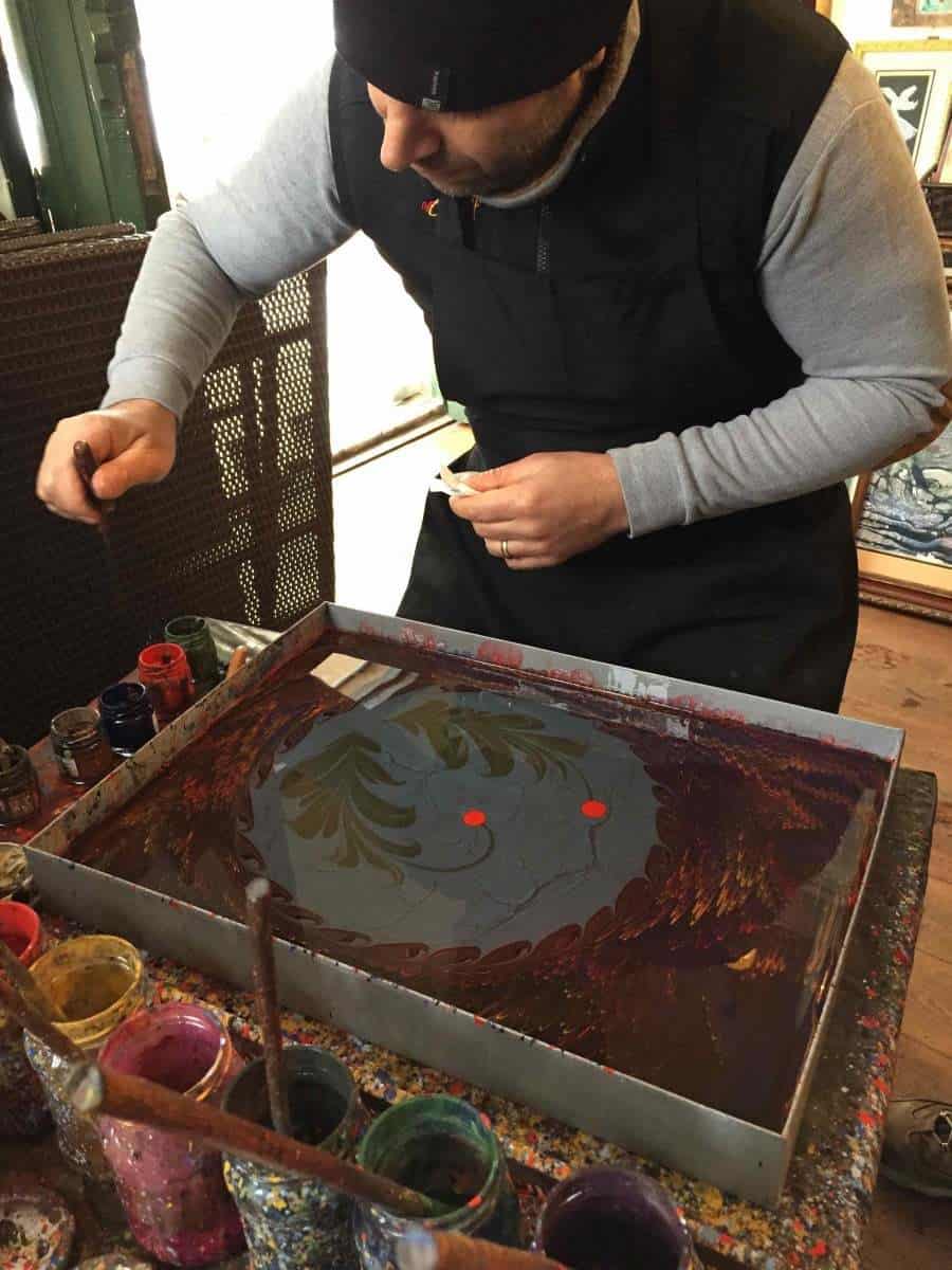 man doing ebru painting in Cafer Aga Madrasa Art College in Istanbul. looking for unique things to see and do in istanbul then pay this art college a visit.